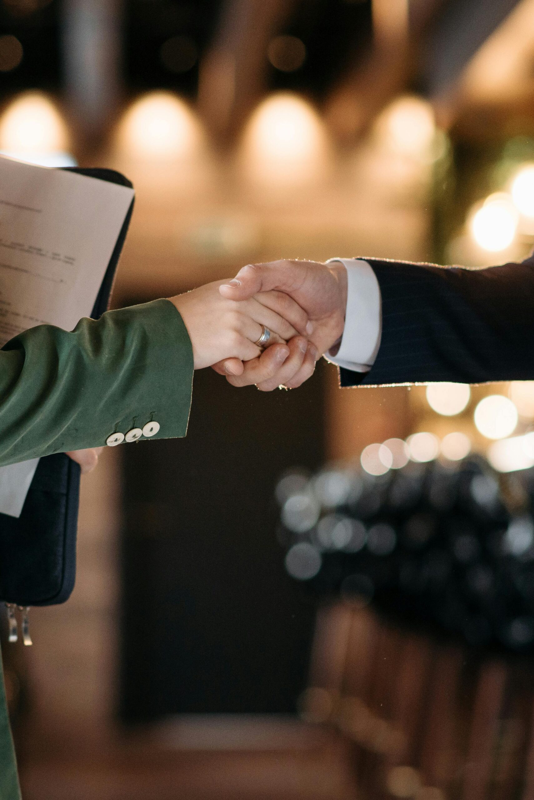 Close-up of two professionals shaking hands, symbolizing a successful partnership agreement.